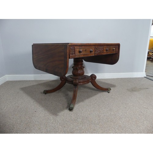 549 - A Regency mahogany and rosewood banded Sofa Table, raised on carved column and quadraform reeded sup... 