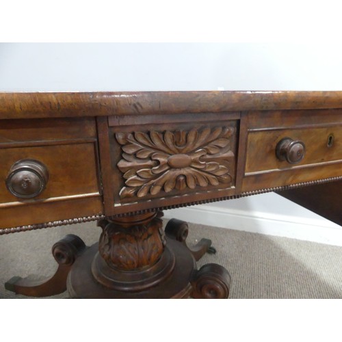 549 - A Regency mahogany and rosewood banded Sofa Table, raised on carved column and quadraform reeded sup... 