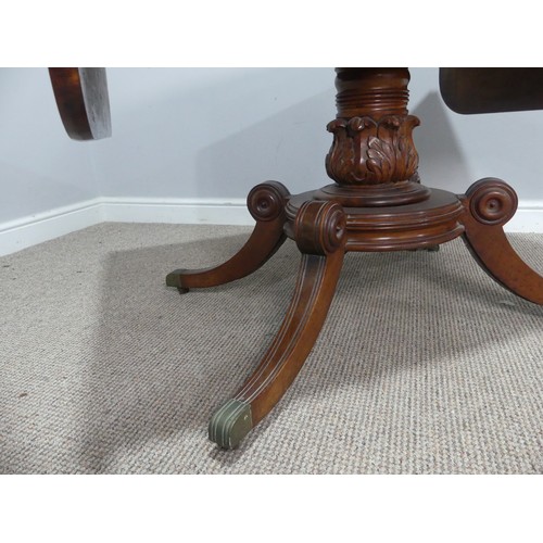 549 - A Regency mahogany and rosewood banded Sofa Table, raised on carved column and quadraform reeded sup... 