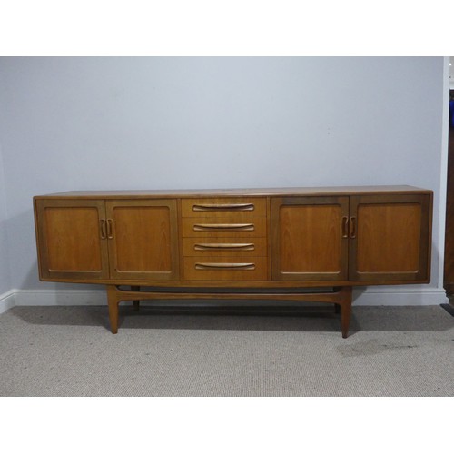 728 - A mid-20th century G-Plan fresco teak Sideboard, with four central drawers flanked by cupboards to e... 