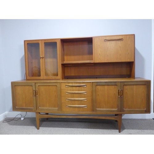 728 - A mid-20th century G-Plan fresco teak Sideboard, with four central drawers flanked by cupboards to e... 