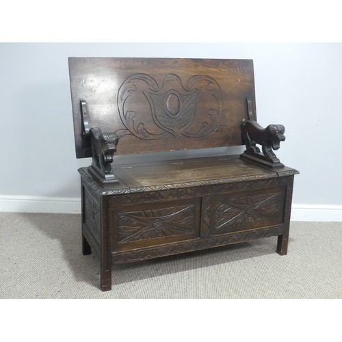 724 - An early 20th century carved oak monks Bench, W 107 cm x H 70 cm x D 50 cm.