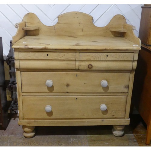 557 - A Victorian pine Chest of drawers, with shaped back rail, over two short and two long drawers, raise... 