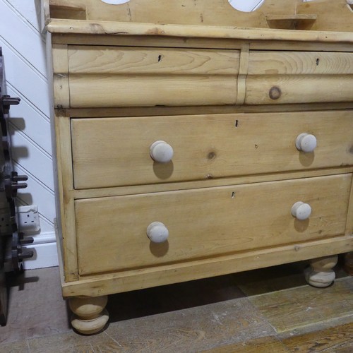 557 - A Victorian pine Chest of drawers, with shaped back rail, over two short and two long drawers, raise... 