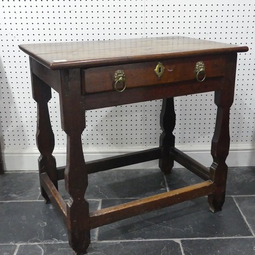 585 - A 18th century oak side Table, rectangular top over single drawer mounted with two brass handles in ... 