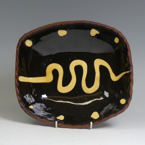 75 - A Ray Finch Winchcombe pottery slipware Dish, with crimped edge, impressed mark to base, W 23cm x L ... 