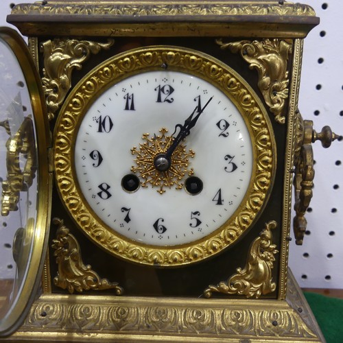 569 - A late 19th century French gilt metal mantle Clock, with a Japy Freres movement, gilt metal urn fini... 