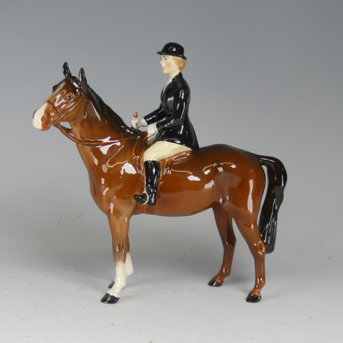 121 - A Beswick figure of a Huntswoman, no. 7130, on brown horse, factory marks to base, H cm.... 