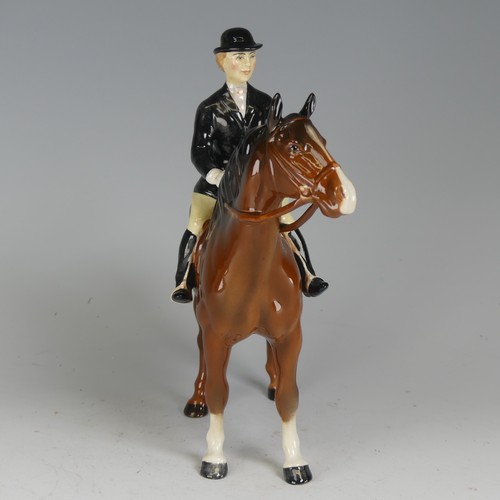 121 - A Beswick figure of a Huntswoman, no. 7130, on brown horse, factory marks to base, H cm.... 