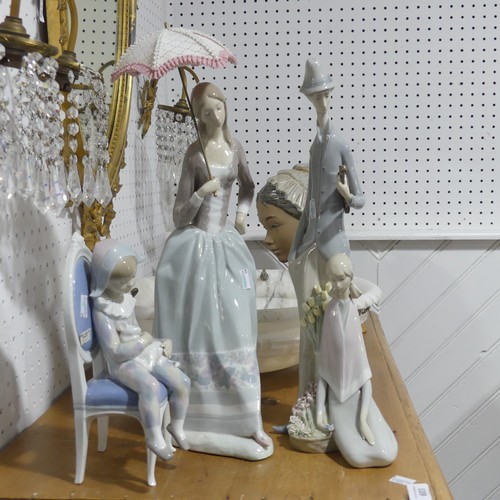 141 - A large Lladro figurine of lady with parasol, H 48cm, together with another large Lladro figurine of... 