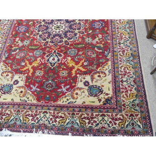 705 - Tribal Rugs; an antique Persian Ardebil carpet, the red ground woven with stylised exotic birds, ani... 