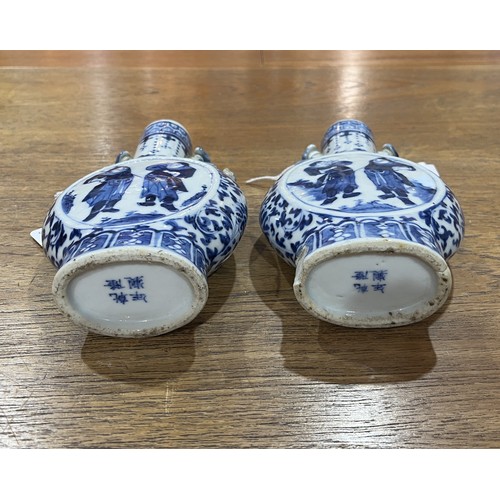 163 - A pair of Chinese blue and white porcelain Moon Vases, with central depiction of two figures, enclos... 