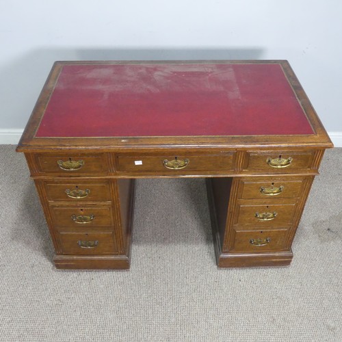 501 - An Edwardian Maple & Co oak twin pedestal Desk, the top inset with red leather writing surface, ... 