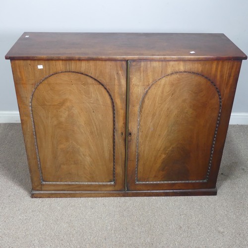 502 - An early 19thC mahogany low Cupboard, with two arched cupboard doors, concealing shelf, raised on pl... 