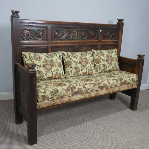 504 - An 18th century style carved oak Settle, the top with carved panels depicting foliate scrolls and he... 