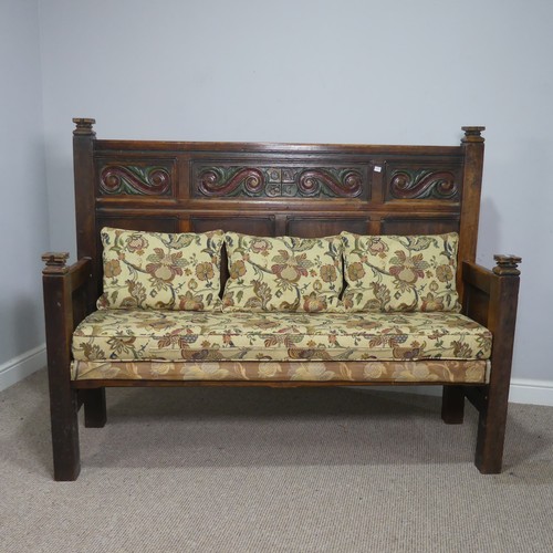 504 - An 18th century style carved oak Settle, the top with carved panels depicting foliate scrolls and he... 