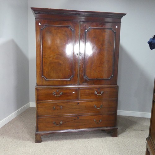 509 - A Georgian flame mahogany Linen Press, the moulded cornice over cupboard drawers concealing slides, ... 