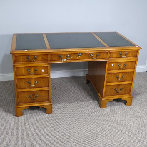 525 - A Brights of Nettlebed hardwood pedestal Desk, the top inset with a three sectional gilt tooled leat... 