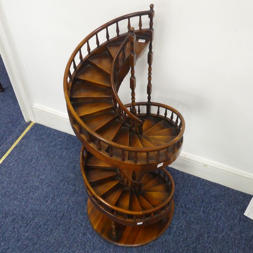 A large fruitwood architectural model of a spiral Staircase, possibly by Theodore Alexander, possibly Masonic, comprising of thirty-two steps and individually hand-turned balusters rising in a double spiral, set on a circular plinth, W 46 cm x H 106 cm x D 46 cm. Note damage to handrail see images. In the 19th and 20th centuries, miniature staircases, along with all sorts of other architectural detailed models, were produced by architects and furniture makers to illustrate proposed features for projects. Collecting staircase models was popularized at the end of the 20th century by the late fashion designer, Bill Blass.