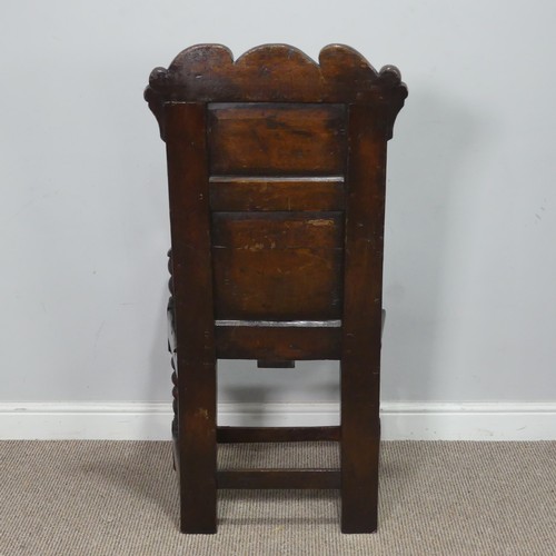 538 - A 17th century oak wainscot Chair, the shaped headrest with carved details, over square seat flanked... 