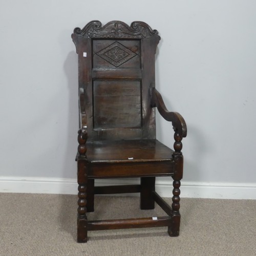 538 - A 17th century oak wainscot Chair, the shaped headrest with carved details, over square seat flanked... 