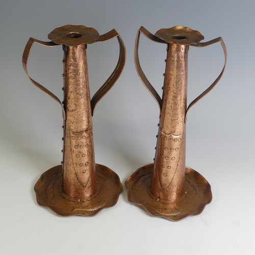 515 - A pair of Arts and Crafts copper Candlesticks, probably by Eustace Brothers, each having a pair of s... 