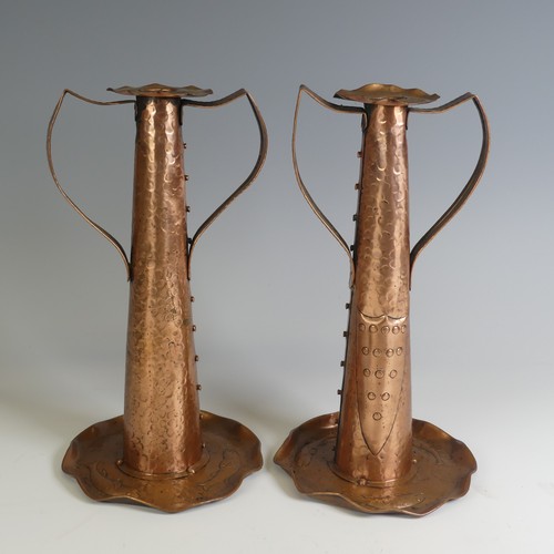 515 - A pair of Arts and Crafts copper Candlesticks, probably by Eustace Brothers, each having a pair of s... 