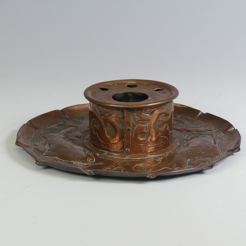 535 - An Arts and Crafts Cornish copper Inkwell, in the manner of Newlyn, the circular dish repousse decor... 