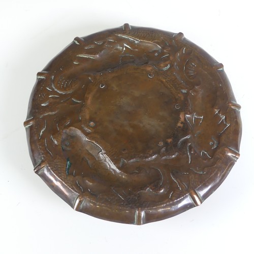 535 - An Arts and Crafts Cornish copper Inkwell, in the manner of Newlyn, the circular dish repousse decor... 