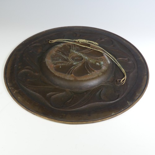 560 - An Arts and Crafts brass Charger, decorated with Art Nouveau inspired stylised foliage, W 46 cm.... 