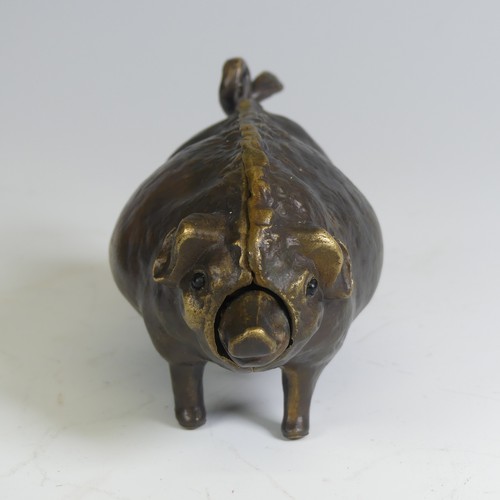 553 - An early 20th century brass butchers countertop Bell, in the form of a pig, inset with glass eyes an... 