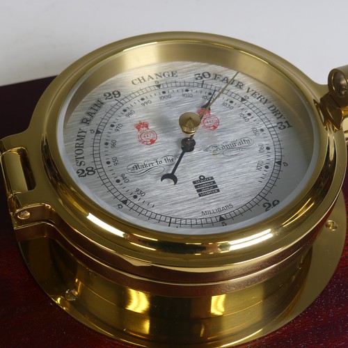 529 - A Sewills of Liverpool brass cased Marine / Ship's Clock and Barometer, both mounted on a single mah... 