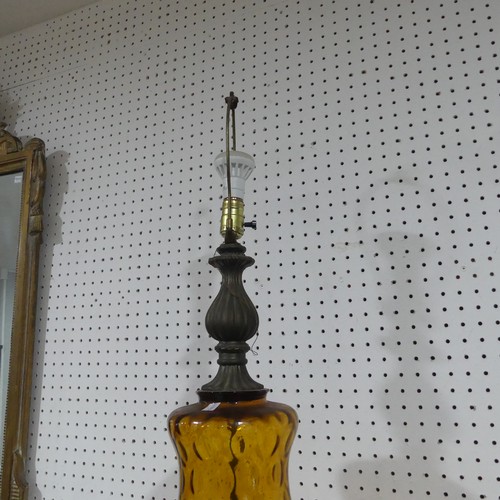 549 - An antique amber glass table Lamp, of bulbous form, raised on brass base, H 90 cm.