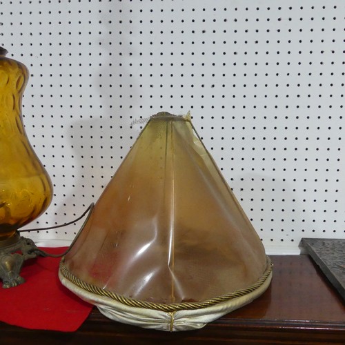 549 - An antique amber glass table Lamp, of bulbous form, raised on brass base, H 90 cm.