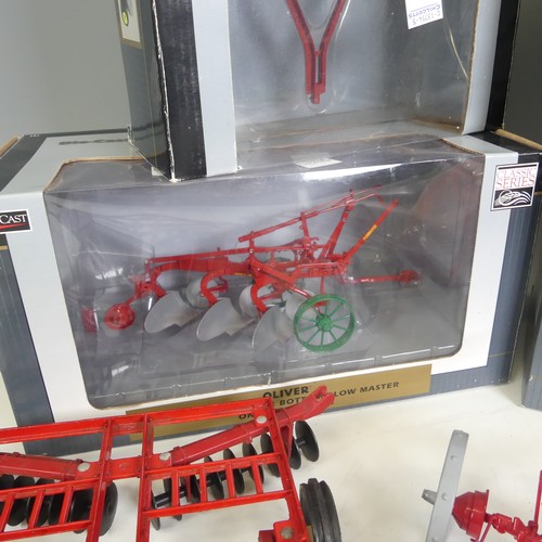 309 - Seven model 1:16 scale ploughs, comprising a Ransomes 3 bottom plow in red, a boxed Speccast Oliver ... 