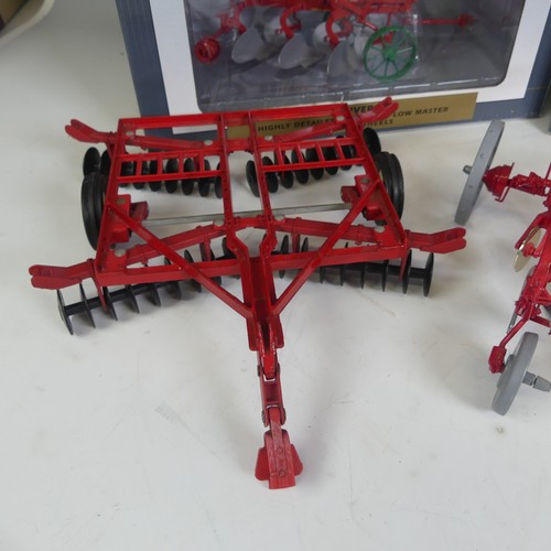 309 - Seven model 1:16 scale ploughs, comprising a Ransomes 3 bottom plow in red, a boxed Speccast Oliver ... 