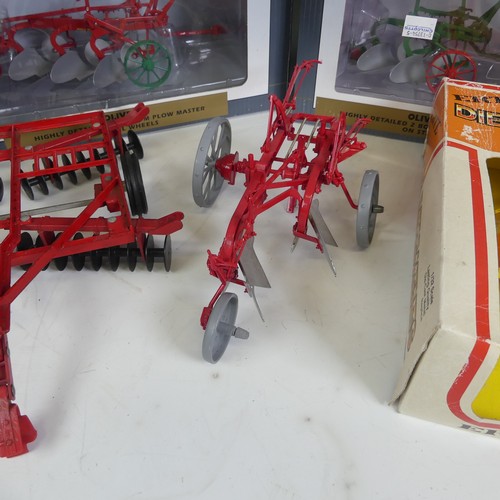 309 - Seven model 1:16 scale ploughs, comprising a Ransomes 3 bottom plow in red, a boxed Speccast Oliver ... 