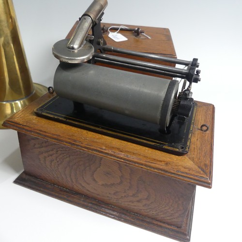 284 - An early 20th century wax cylinder Phonograph, with reproducer and brass horn, in oak case, together... 