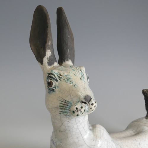 365 - Lawson E. Rudge (b. 1936), a raku fired studio pottery sculpture of a Hare, modelled cross legged, L... 