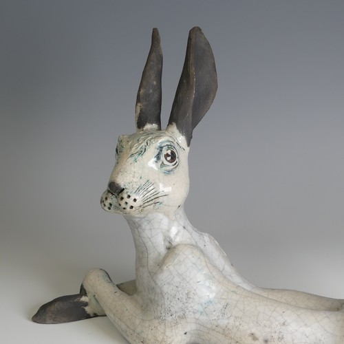 365 - Lawson E. Rudge (b. 1936), a raku fired studio pottery sculpture of a Hare, modelled cross legged, L... 