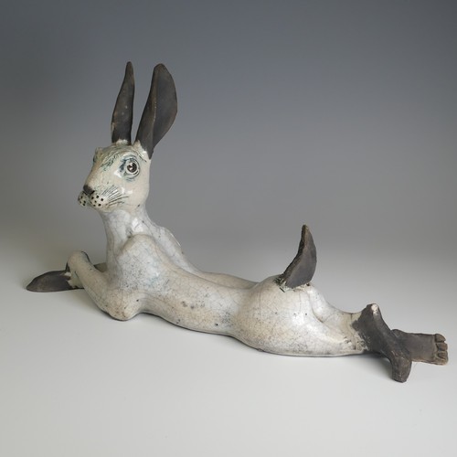 365 - Lawson E. Rudge (b. 1936), a raku fired studio pottery sculpture of a Hare, modelled cross legged, L... 