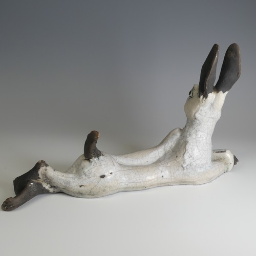 365 - Lawson E. Rudge (b. 1936), a raku fired studio pottery sculpture of a Hare, modelled cross legged, L... 