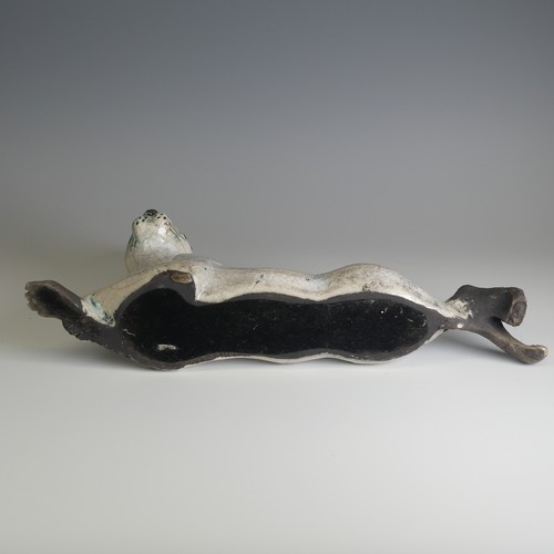 365 - Lawson E. Rudge (b. 1936), a raku fired studio pottery sculpture of a Hare, modelled cross legged, L... 