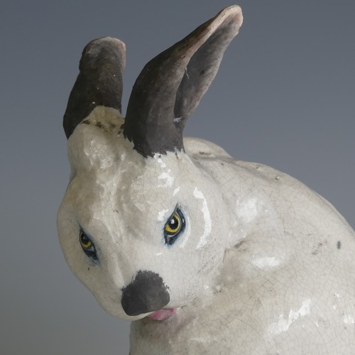 366 - Keza Rudge (British 20th century) a studio pottery Raku Rabbit, modelled in seated position with tur... 