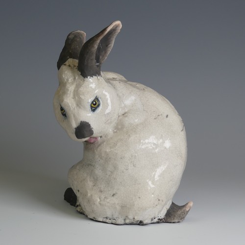 366 - Keza Rudge (British 20th century) a studio pottery Raku Rabbit, modelled in seated position with tur... 