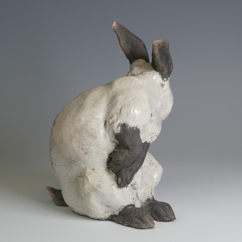 366 - Keza Rudge (British 20th century) a studio pottery Raku Rabbit, modelled in seated position with tur... 