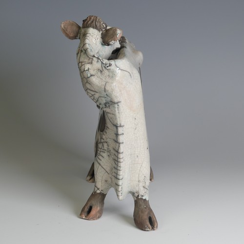 367 - Lawson E. Rudge (b. 1936), a raku fired pottery sculpture of a licking Flat Cow, spot pattern and nu... 