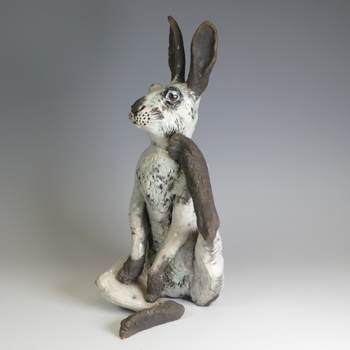 368 - Lawson E. Rudge (b. 1936), a raku fired studio pottery sculpture of a Hare, modelled scratching, H 4... 