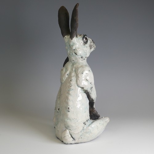 368 - Lawson E. Rudge (b. 1936), a raku fired studio pottery sculpture of a Hare, modelled scratching, H 4... 