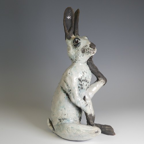 368 - Lawson E. Rudge (b. 1936), a raku fired studio pottery sculpture of a Hare, modelled scratching, H 4... 